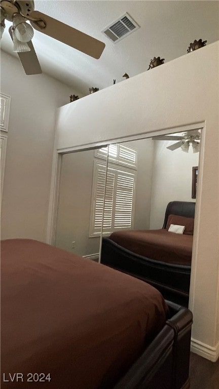 bedroom with a closet, ceiling fan, and lofted ceiling