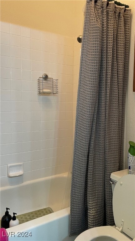 bathroom with toilet and shower / tub combo with curtain