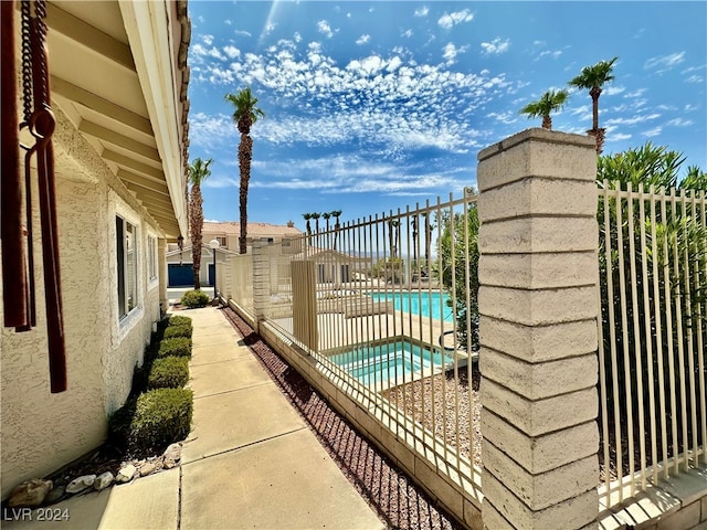 view of pool featuring an in ground hot tub