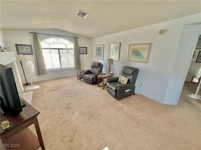 2153 Camel Mesa Dr, Laughlin, NV 89029 - sitting room featuring vaulted ceiling, carpet floors, and a textured ceiling