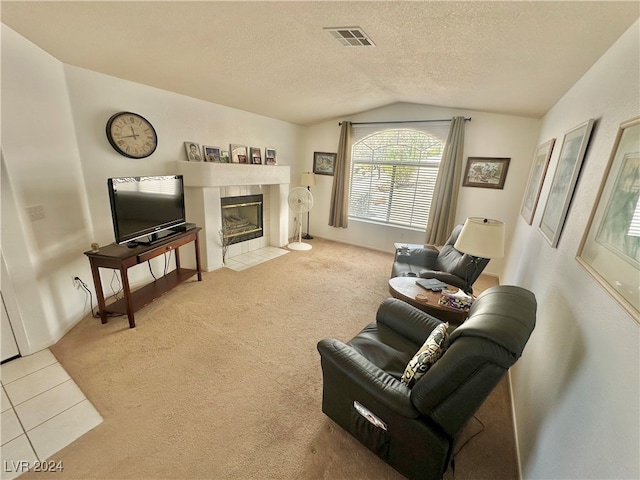 carpeted living room with a textured ceiling, a fireplace, and vaulted ceiling