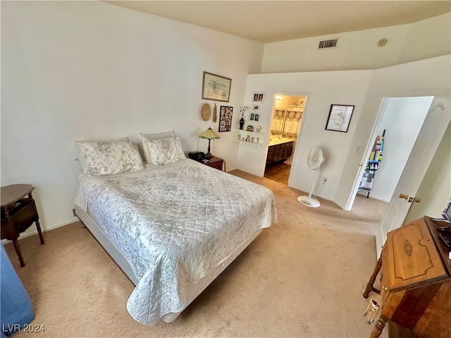 carpeted bedroom featuring connected bathroom