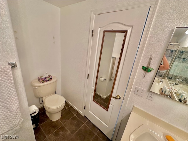 bathroom featuring tile patterned flooring and toilet