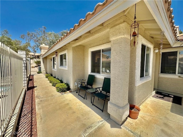 2153 Camel Mesa Dr, Laughlin, NV 89029 - view of property exterior with stucco siding, a patio area, and a tiled roof