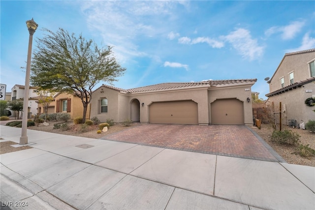 mediterranean / spanish-style home featuring a garage