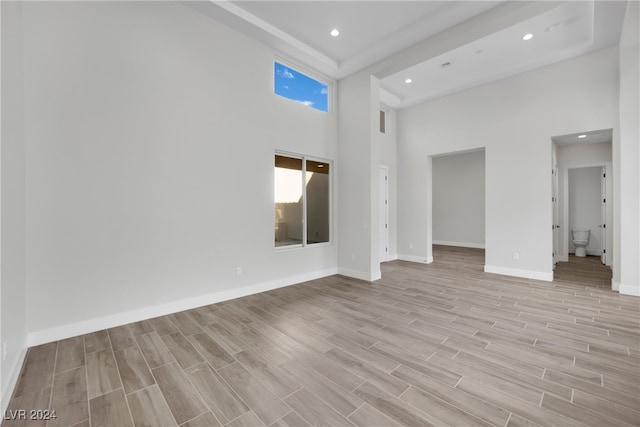 interior space with a towering ceiling and light wood-type flooring