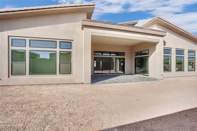 back of property with a patio