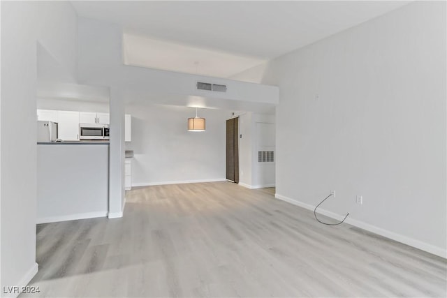 unfurnished living room featuring light wood-type flooring