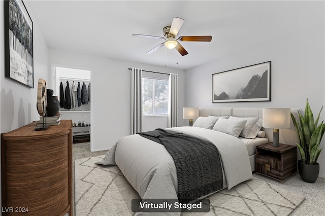 carpeted bedroom featuring a spacious closet, a closet, and ceiling fan