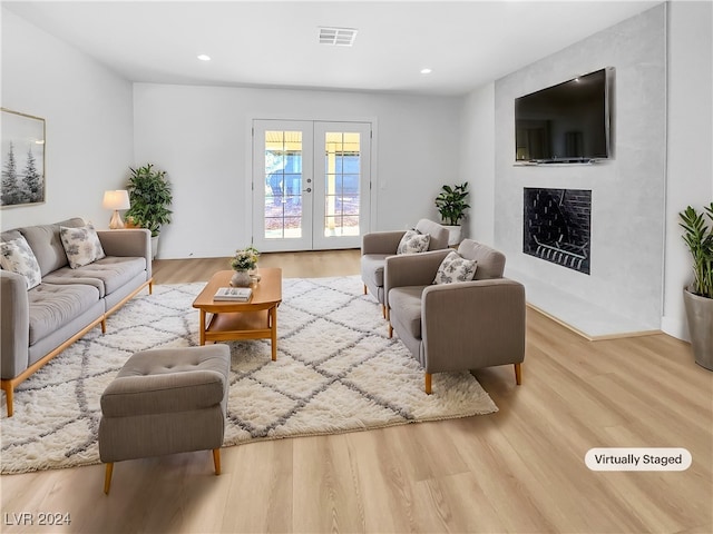 living room with hardwood / wood-style flooring and french doors