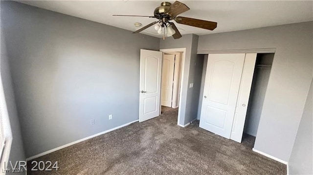 unfurnished bedroom with ceiling fan, a closet, and dark colored carpet