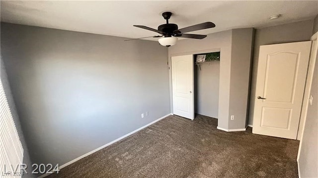 unfurnished bedroom with dark colored carpet, ceiling fan, and a closet