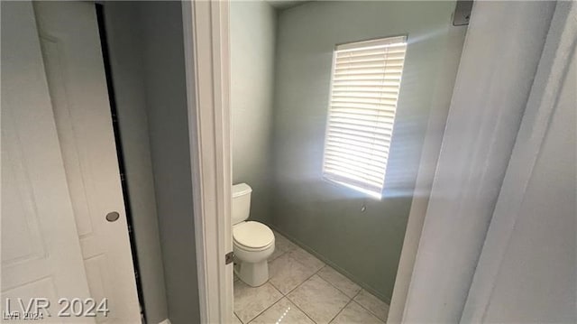 bathroom featuring tile patterned flooring and toilet