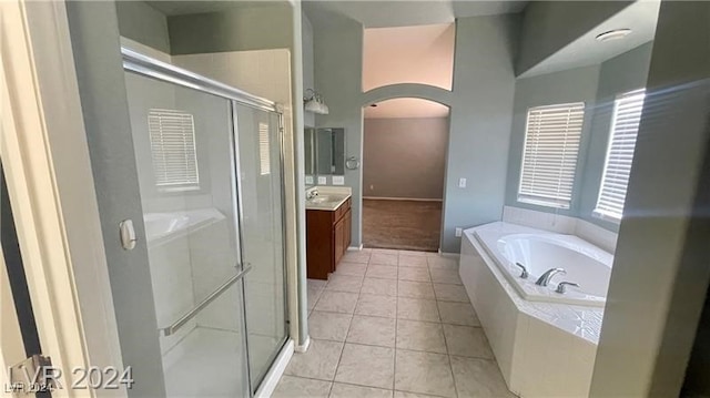 bathroom featuring tile patterned flooring, vanity, and separate shower and tub