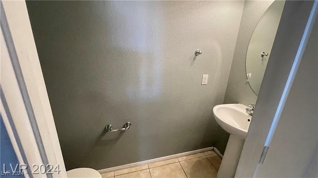 bathroom with tile patterned floors