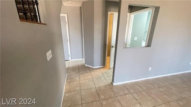 hall with light tile patterned floors