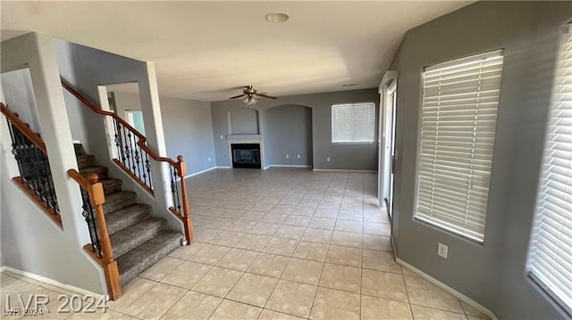 interior space with ceiling fan and light tile patterned flooring