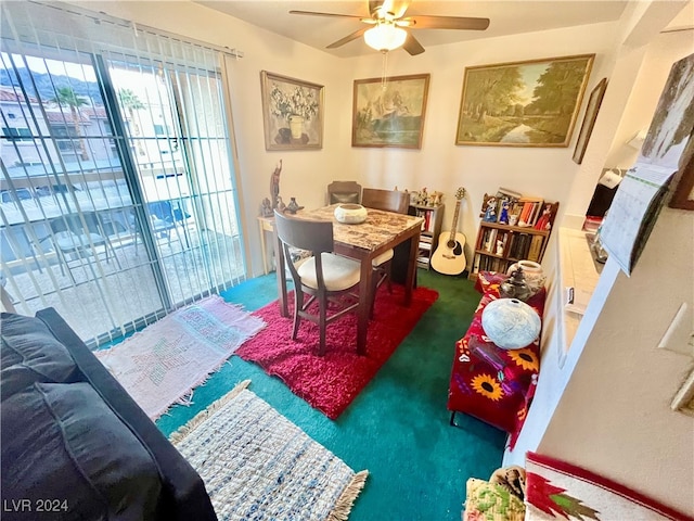 carpeted dining area with ceiling fan