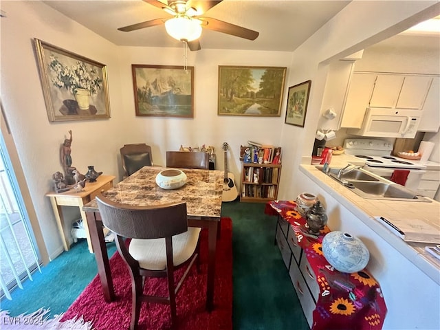 dining area with carpet floors, ceiling fan, and sink