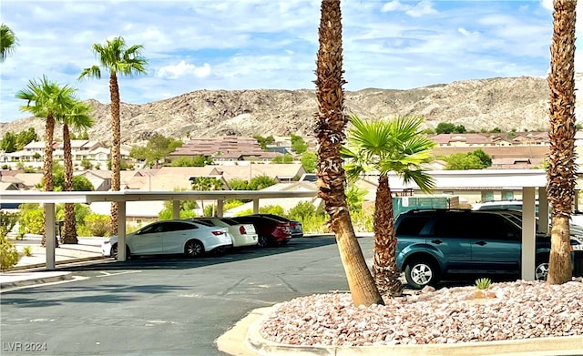 view of vehicle parking featuring a mountain view