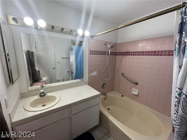 bathroom with shower / bath combo with shower curtain, vanity, and tile patterned flooring