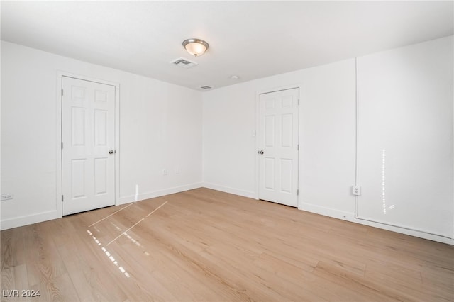 spare room featuring light hardwood / wood-style flooring