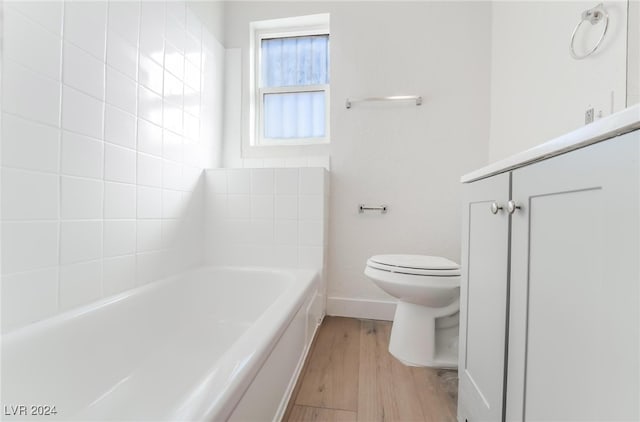 bathroom featuring toilet, a bath, and hardwood / wood-style flooring