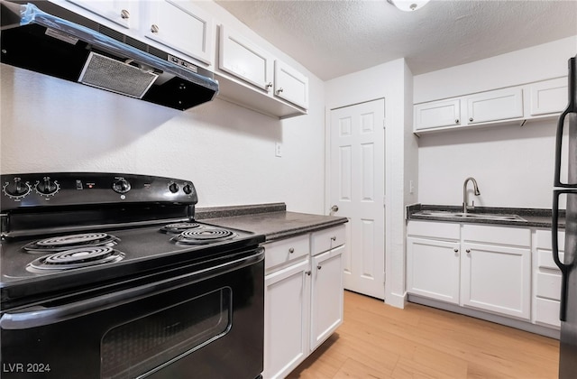 kitchen with black electric range, white cabinetry, and extractor fan