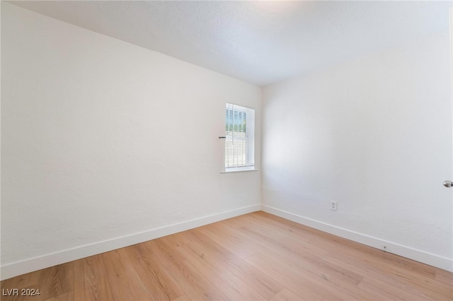 unfurnished room with light wood-type flooring