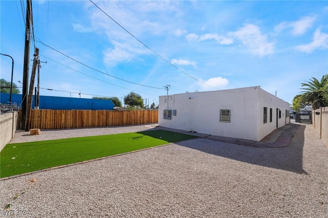 rear view of house featuring a lawn