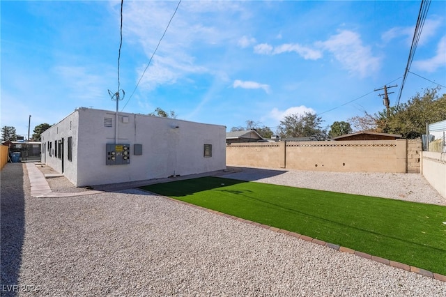 back of property featuring a lawn