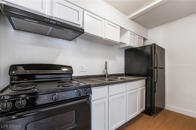 kitchen featuring sink, black appliances, white cabinets, exhaust hood, and light wood-type flooring