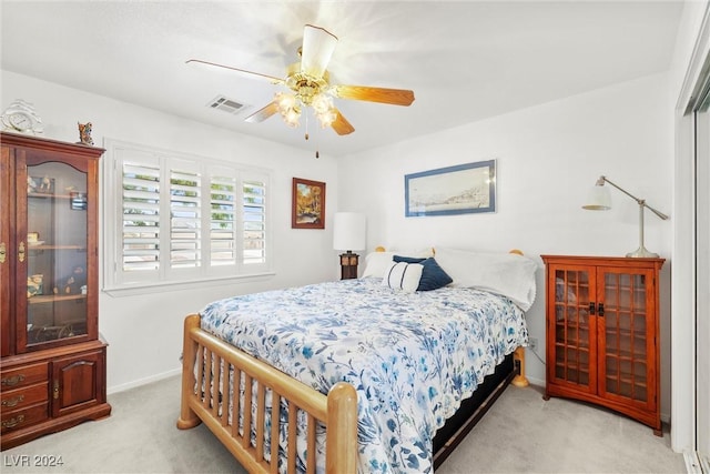 bedroom featuring light carpet and ceiling fan