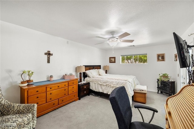 bedroom with ceiling fan and light carpet