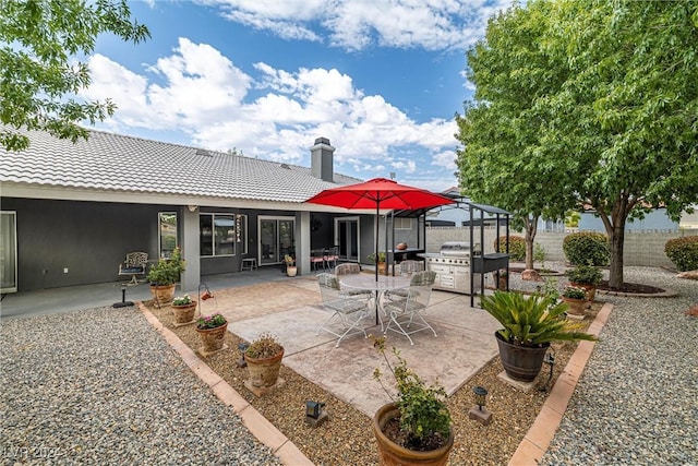 back of property with a gazebo and a patio area