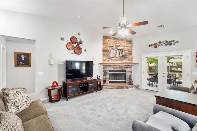 living room with french doors, a fireplace, carpet flooring, and vaulted ceiling