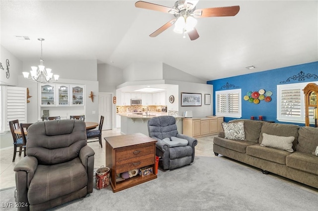 living room with lofted ceiling and ceiling fan with notable chandelier