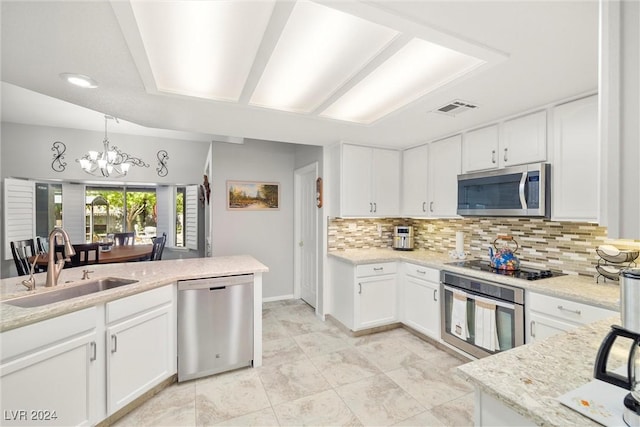 kitchen with sink, tasteful backsplash, decorative light fixtures, appliances with stainless steel finishes, and white cabinets