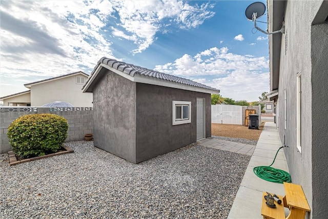 view of home's exterior featuring a patio area and an outdoor structure