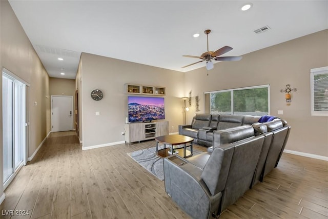 living room featuring light hardwood / wood-style flooring and ceiling fan