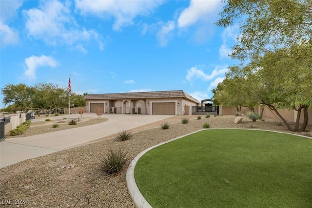 view of front of house with a garage, concrete driveway, stucco siding, and fence