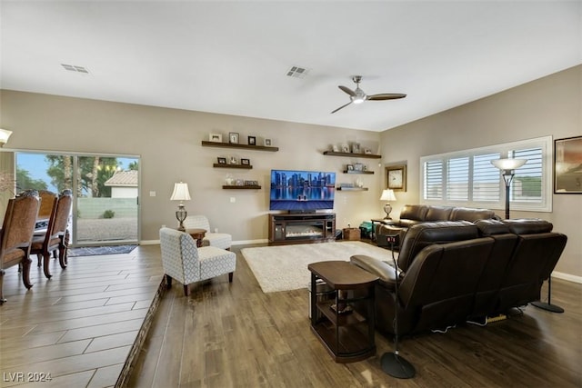 living room featuring wood-type flooring and ceiling fan