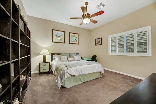 carpeted bedroom with a ceiling fan, baseboards, and visible vents