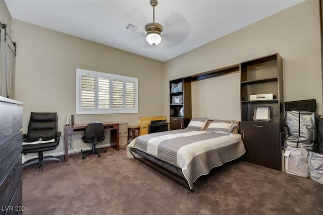 carpeted bedroom with visible vents, a barn door, baseboards, and a ceiling fan