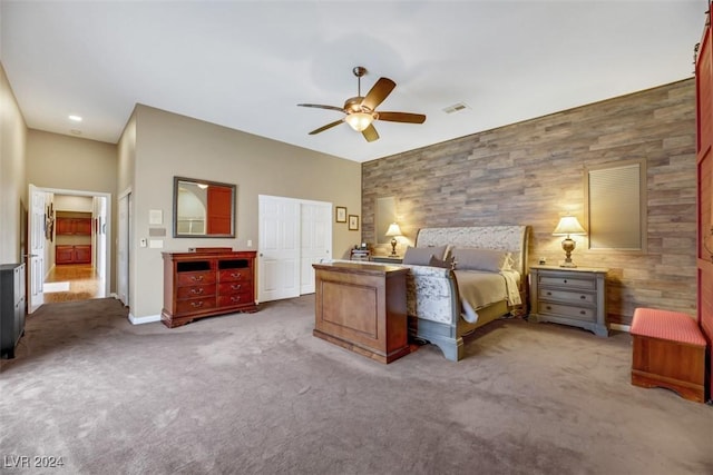 carpeted bedroom featuring ceiling fan and a closet