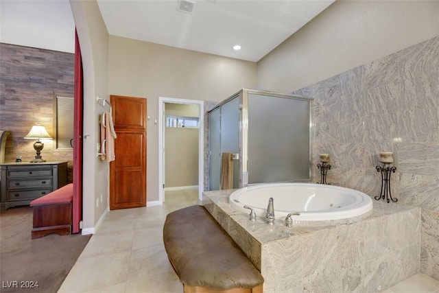 bathroom with tile patterned flooring, baseboards, a garden tub, decorative backsplash, and a stall shower