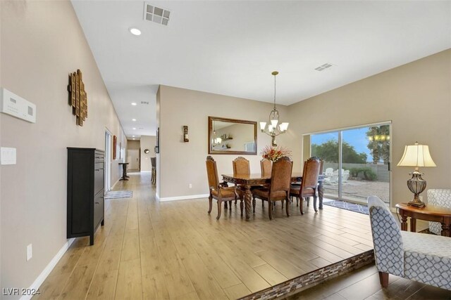 dining area featuring an inviting chandelier and light wood-type flooring