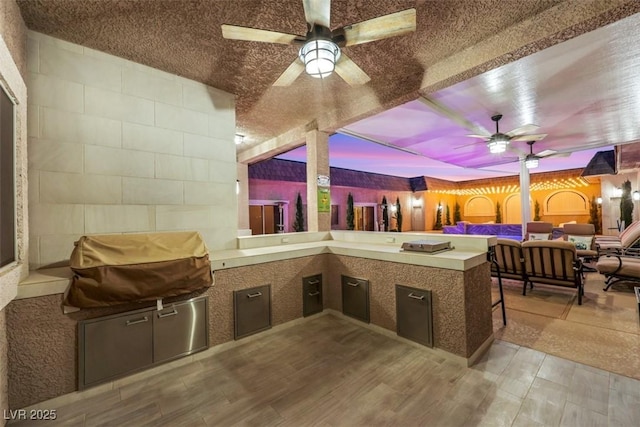 view of patio / terrace with grilling area, an outdoor living space, exterior kitchen, and ceiling fan