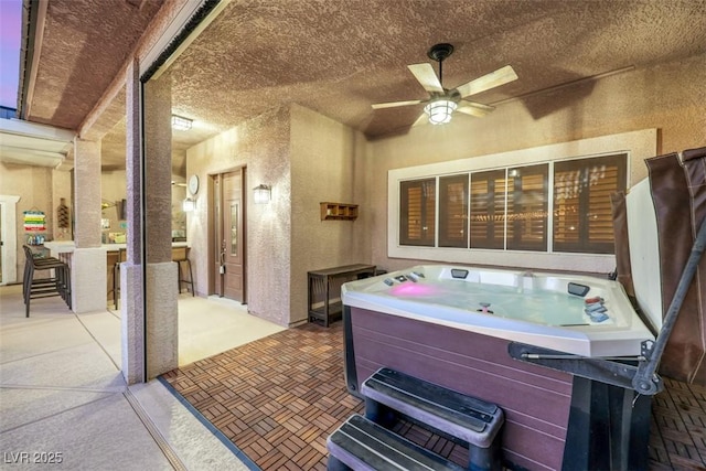 view of patio featuring a hot tub and ceiling fan