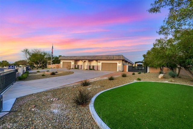 view of front of house with a front lawn, an attached garage, fence, and concrete driveway